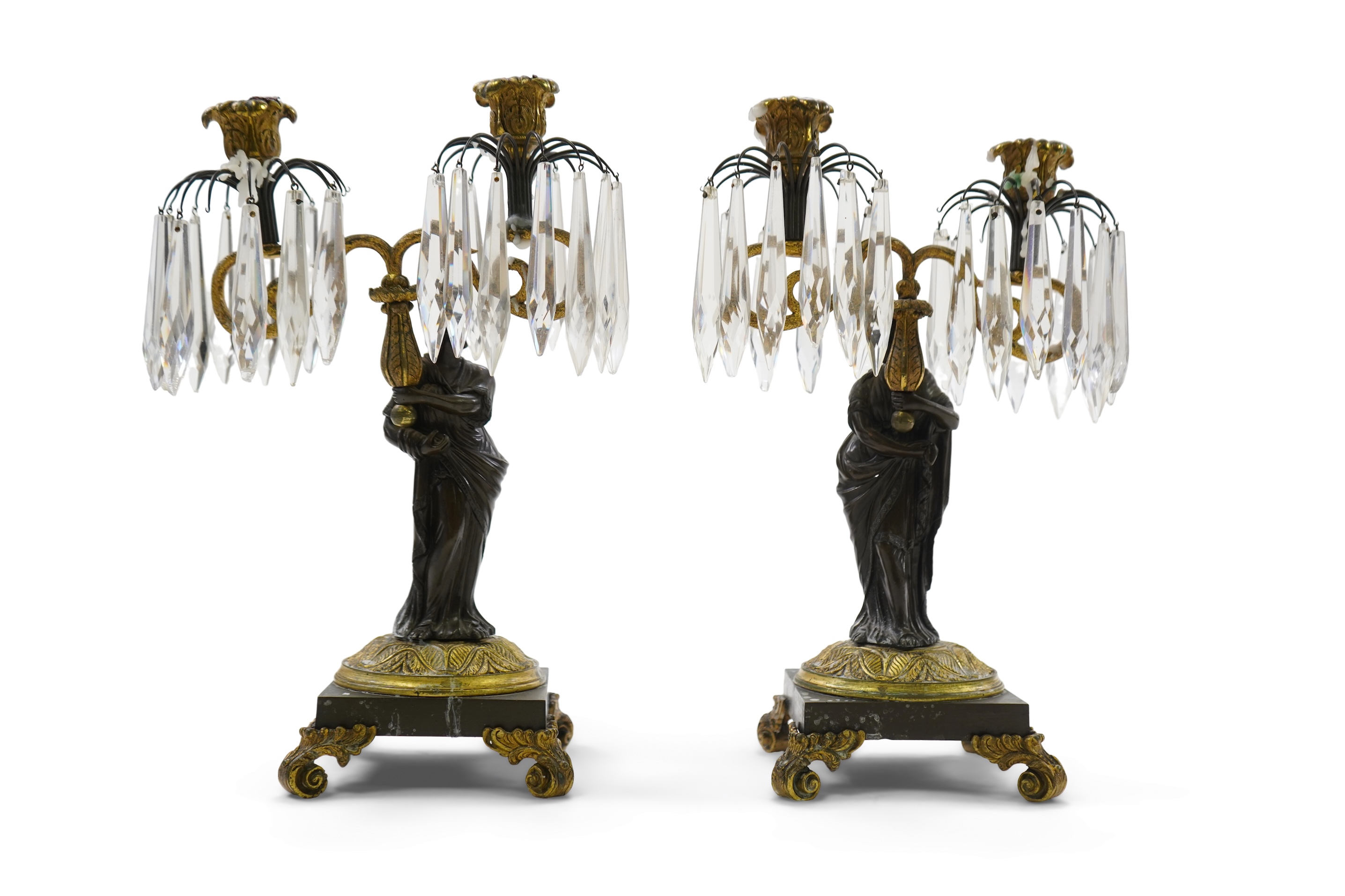 After Mathurin Moreau. A pair of mid 19th century bronze and gilt bronze two branch candelabra